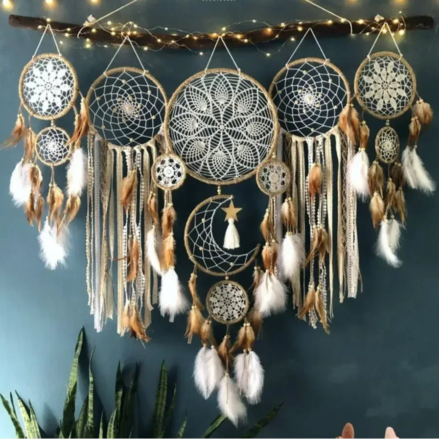 Un arrangement mural décoratif présente plusieurs attrape-rêves suspendus à une branche. Les détails complexes en macramé forment des motifs délicats à l'intérieur de chaque cercle. Des plumes douces et des cordes texturées pendent gracieusement, créant une ambiance bohème et artisanale.