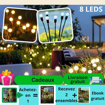 Une scène de jardin met en valeur Lucio-Light™ de lecoledeschats, avec des sphères LED lumineuses sur des bâtons. Les offres en français apparaissent au premier plan : « Achetez-en 1 Recevez 2 ensembles » et « Livraison gratuite », avec des icônes pour les cadeaux, la livraison gratuite et linstallation facile (sans fil).