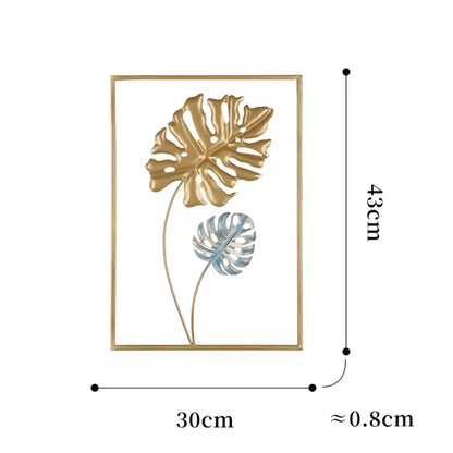 Élégante decoration murale métallique feuilles monstera dorées et argentées encadrées, style tropical moderne.
