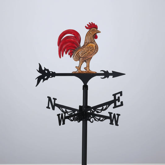 Girouette coq décorative sur fond hivernal enneigé.