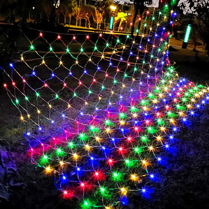Guirlande rideau solaire lumineuse multicolore décorant un arbre dans un jardin.