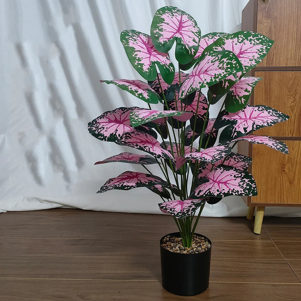plantes artificielle exterieur Monstera artificielle géante avec feuilles roses et vertes, intérieur.