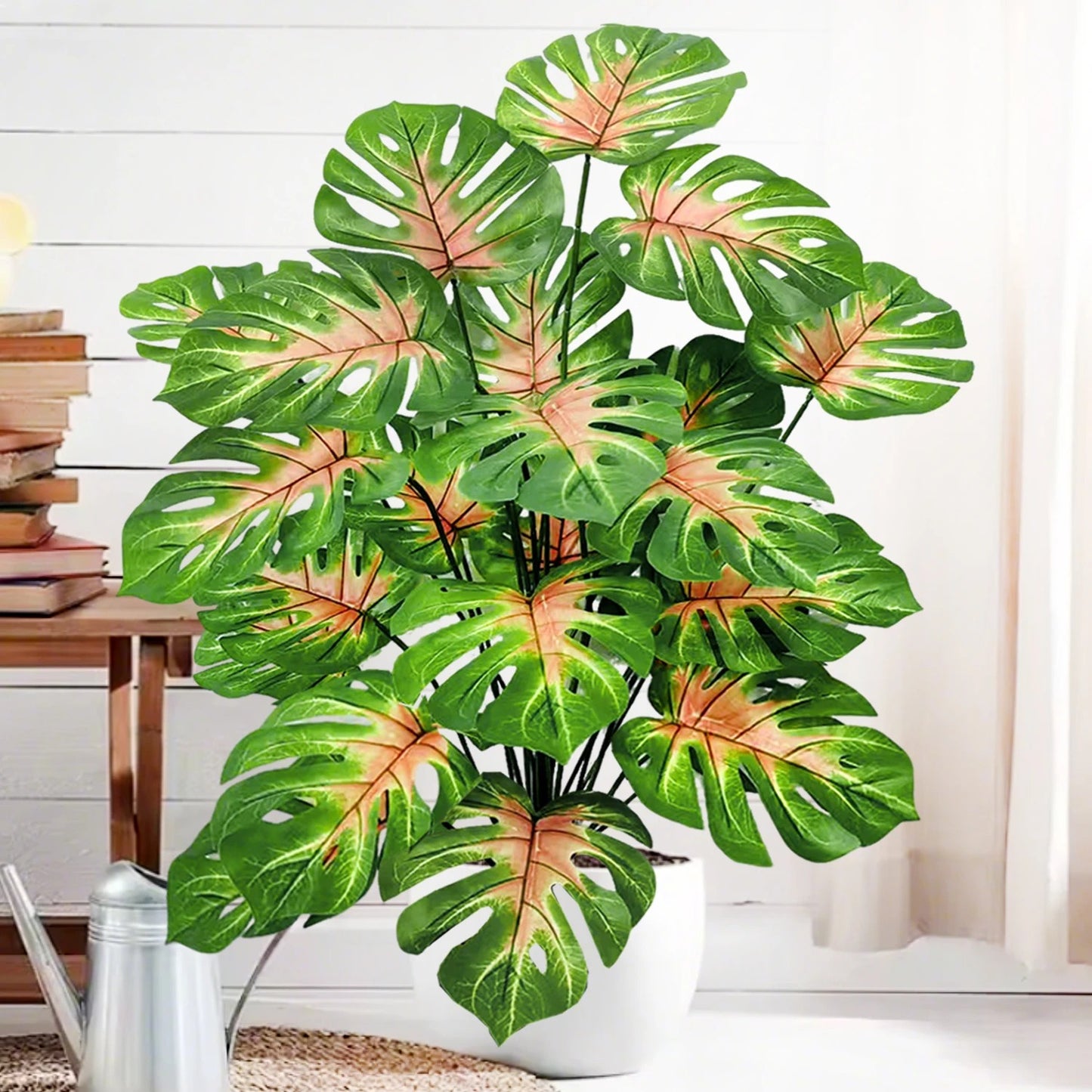 Plante artificielle de Philodendron 'Rose Éclat' avec de grandes feuilles vertes et roses, placée dans un pot blanc moderne dans un salon contemporain. Parfait pour une décoration intérieure sans entretien."