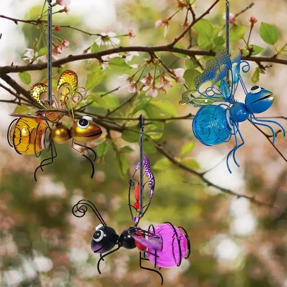 Vue ensemble jardin transformé décoration jardin abeille suspendue arbre espace poétique point focal lumineux harmonieux enchanteur